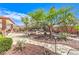 Landscaped backyard showcasing stone pathways, desert plants, and mature trees at 7521 Dry Pines Cir, Las Vegas, NV 89129