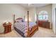 This spacious bedroom boasts a four poster bed with a unique comforter and decorative pillows at 7521 Dry Pines Cir, Las Vegas, NV 89129