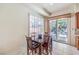 Dining area featuring a four chair dining table, view through window to outdoor living space at 7521 Dry Pines Cir, Las Vegas, NV 89129
