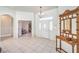 Welcoming foyer featuring white tile floors and a vintage coat rack at 7521 Dry Pines Cir, Las Vegas, NV 89129
