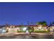 Charming single-story home featuring a tile roof, lush landscaping, and an attached two-car garage at 7521 Dry Pines Cir, Las Vegas, NV 89129