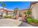 Well-maintained front yard featuring lush landscaping, a secure gate, and a paved driveway leading to the garage at 7521 Dry Pines Cir, Las Vegas, NV 89129