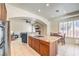 Open kitchen concept flows into living area with island cooktop and nearby dining table at 7521 Dry Pines Cir, Las Vegas, NV 89129