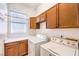 Functional laundry room with modern washer and dryer, and ample cabinet space at 7521 Dry Pines Cir, Las Vegas, NV 89129