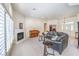 Comfortable living room features a fireplace, piano, and neutral-colored furnishings at 7521 Dry Pines Cir, Las Vegas, NV 89129