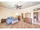 Main bedroom featuring tile floors, ceiling fan, and connected bathroom access at 7521 Dry Pines Cir, Las Vegas, NV 89129
