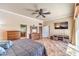 Spacious bedroom with connected bathroom, entertainment center, and exterior views at 7521 Dry Pines Cir, Las Vegas, NV 89129
