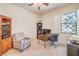 Home office with a cozy chair, desk, and natural light from the window at 7521 Dry Pines Cir, Las Vegas, NV 89129