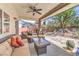 Inviting covered patio with comfortable seating and a beautifully landscaped yard at 7521 Dry Pines Cir, Las Vegas, NV 89129