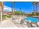 Beautiful pool with lounge chairs and a view of the lush landscaping and blue skies at 7521 Dry Pines Cir, Las Vegas, NV 89129