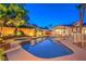 Relaxing backyard pool featuring a spa, ample seating, and lush landscaping, perfect for outdoor entertaining at 7521 Dry Pines Cir, Las Vegas, NV 89129