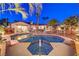 Inviting backyard pool area with a spa, comfortable seating, and lush landscaping for the ultimate oasis at 7521 Dry Pines Cir, Las Vegas, NV 89129