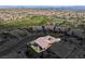 An aerial view reveals a well-maintained home in a desert community with beautiful surroundings at 775 Porto Mio Way, Las Vegas, NV 89138