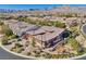 A high-angle shot reveals lush landscaping, desert hardscape, and a tile roof in a suburban neighborhood at 775 Porto Mio Way, Las Vegas, NV 89138