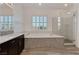 Bright bathroom with double vanity, soaking tub, walk-in glass shower, and plantation shutters at 775 Porto Mio Way, Las Vegas, NV 89138