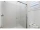 Bright bathroom with a modern glass shower and shuttered window providing natural light at 775 Porto Mio Way, Las Vegas, NV 89138