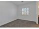 This bedroom has a window with bright natural light, neutral carpet and freshly painted walls at 775 Porto Mio Way, Las Vegas, NV 89138