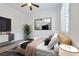 This staged bedroom features a large bed, stylish decorations, and bright natural light from the window at 775 Porto Mio Way, Las Vegas, NV 89138