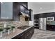 Modern kitchen with granite countertops, stainless steel appliances, and stylish tile backsplash at 775 Porto Mio Way, Las Vegas, NV 89138