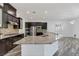 Modern kitchen with a large island, stainless steel appliances, and tiled backsplash at 775 Porto Mio Way, Las Vegas, NV 89138