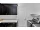 This laundry room is equipped with cabinets, counter space, and modern washer and dryer at 775 Porto Mio Way, Las Vegas, NV 89138