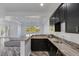 Open living area with sleek countertops, dark cabinetry, and access to natural light at 775 Porto Mio Way, Las Vegas, NV 89138
