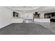 Spacious open floor plan with gray carpet and access to the kitchen at 775 Porto Mio Way, Las Vegas, NV 89138