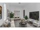This living room is staged with tasteful furniture, modern flooring, and bright light at 775 Porto Mio Way, Las Vegas, NV 89138