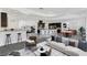 This open floor plan has a kitchen with a bar and a living area with nice furniture at 775 Porto Mio Way, Las Vegas, NV 89138