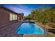 Sparkling pool and spa with mature landscaping and a beautiful sunset view at 775 Porto Mio Way, Las Vegas, NV 89138
