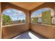 Arched balcony overlooking a green residential area with clear skies, offering a serene outdoor space at 7950 W Flamingo Rd # 2066, Las Vegas, NV 89147