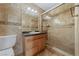 A bathroom with a vanity, glass shower, and tiled walls at 7950 W Flamingo Rd # 2066, Las Vegas, NV 89147