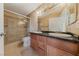 A bathroom with granite counters, double sinks, and a glass shower at 7950 W Flamingo Rd # 2066, Las Vegas, NV 89147