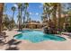 Community pool with rock waterfall feature and chairs for relaxing outdoors at 7950 W Flamingo Rd # 2066, Las Vegas, NV 89147