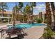 Community pool with tables and chairs, rock waterfall feature, and well-manicured greenery at 7950 W Flamingo Rd # 2066, Las Vegas, NV 89147