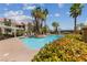 Community pool area with palm trees, lounge chairs, and well-maintained landscaping at 7950 W Flamingo Rd # 2066, Las Vegas, NV 89147