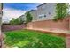 Private backyard featuring a well-maintained lawn and brick perimeter, perfect for outdoor entertaining at 8087 Carpenter Creek Ave, Las Vegas, NV 89113