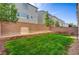 Spacious backyard with a green lawn and brick walls, creating a private outdoor area at 8087 Carpenter Creek Ave, Las Vegas, NV 89113