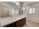 Bright bathroom showcases a double vanity with dark cabinets and a shower with a tub combination at 8087 Carpenter Creek Ave, Las Vegas, NV 89113