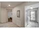 Hallway with tiled floors leading to a laundry area and bedroom at 8087 Carpenter Creek Ave, Las Vegas, NV 89113