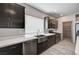 Close up of a modern kitchen featuring stainless steel appliances and dark wood cabinets at 8087 Carpenter Creek Ave, Las Vegas, NV 89113