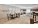 Open concept kitchen and dining area, featuring tile flooring, dark wood cabinets and quartz countertops at 8087 Carpenter Creek Ave, Las Vegas, NV 89113
