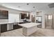 Modern kitchen with stainless steel appliances, spacious island, and wood-look tile flooring at 8087 Carpenter Creek Ave, Las Vegas, NV 89113