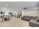 Open-concept living area boasts tile flooring, modern lighting, and a comfortable gray sectional sofa at 8087 Carpenter Creek Ave, Las Vegas, NV 89113