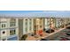 View of contemporary townhomes with well-maintained landscaping and colorful garage doors at 8087 Carpenter Creek Ave, Las Vegas, NV 89113