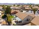 Backyard aerial view featuring patio cover, tile roof, landscaping, and mature trees at 812 Rio Poco Ct, Henderson, NV 89015