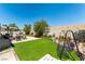 Lush backyard features artificial turf, a patio, and a shaded swing at 812 Rio Poco Ct, Henderson, NV 89015