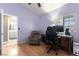 This bedroom features light purple paint and wood floors, a desk, and a chair at 812 Rio Poco Ct, Henderson, NV 89015
