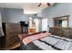 Primary bedroom boasts wood floors, TV, and dresser at 812 Rio Poco Ct, Henderson, NV 89015