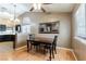A dining table sits near the window, with adjacent access to the kitchen, showcasing a modern, functional space at 812 Rio Poco Ct, Henderson, NV 89015